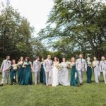 A group of bridesmaids and groomsmen posing for a wedding portrait.