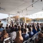 A deck wedding ceremony overlooking a lake.