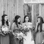 A wedding portrait of bridesmaids in front of a barn.