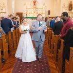 A bride and groom participating in their wedding ceremony at a church.