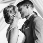 A couple exchanges a kiss at their wedding ceremony.