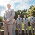 A group of groomsmen participating in a wedding ceremony.