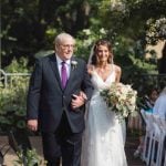 A bride gracefully walks down the aisle during her wedding ceremony.