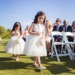 Two little girls participating in a wedding ceremony.