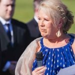 A woman is speaking during a wedding ceremony.