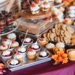 A wedding dessert table with cupcakes and other desserts.