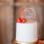 A detailed wedding cake decorated with orange flowers.