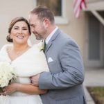 A portrait of a bride and groom embracing on their wedding day.