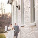 A wedding portrait of a bride and groom in front of a building.