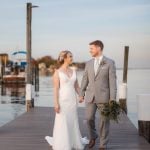 A wedding portrait featuring a bride and groom on a dock.