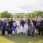 A group of people posing for a portrait on a golf course.