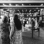 A black and white photo of a group of people at a reception.