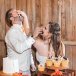 Reception: A bride and groom cutting their wedding cake at the reception.