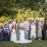 A wedding portrait featuring the happy couple in front of a tree.