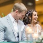 A couple laughing at their wedding reception.