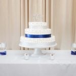 A detailed wedding cake on a table.