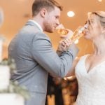 A couple toasting at their wedding reception.