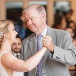 A father and daughter dance at a wedding reception.