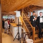 A man in a tuxedo is standing at a wedding reception.