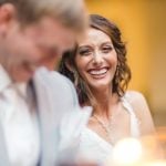 A wedding reception where the bride and groom share a smile.