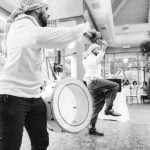 Two men playing drums at a wedding reception.