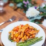 A wedding table with pasta and asparagus.