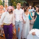 A couple walks down the aisle at their wedding.