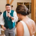 A couple singing at their wedding reception.