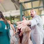 A wedding reception featuring a lively group of people dancing.