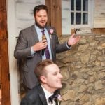 A groom delivering a speech at a wedding reception.