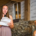 A woman is giving a speech during a wedding reception.