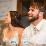 A couple happily exchanging vows at their wedding reception.