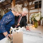 A man and woman admiring a wedding reception table.