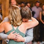 A couple embracing during their wedding reception.