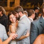 A bride and groom embracing at their wedding reception.