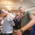 A group of people dancing at a wedding reception.