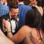 A man dancing at a wedding reception.