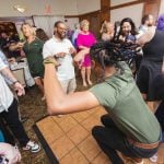 A group of people dancing at a wedding reception.