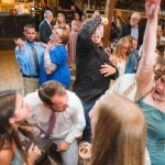 A group of people dancing at a reception.