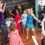 A group of people celebrating at a wedding reception.