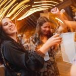 A group of people having fun at a wedding reception.