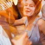 A group of people having a good time at a wedding reception.