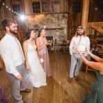 Keywords used: Reception, Wedding

Description: A couple cutting a wedding cake during their reception in a rustic barn.