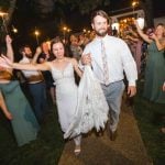 A bride and groom depart from their wedding reception.