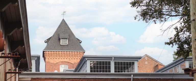 The Great Room at Savage Mill is a brick building with a clock tower.