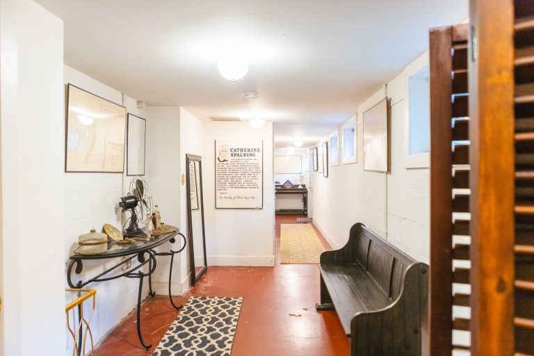 A Pleasant Hill House hallway adorned with a bench and a picture on the wall, creating an ideal wedding venue.