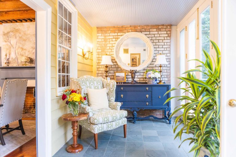 Pleasant Hill House with a blue chair and a fireplace.