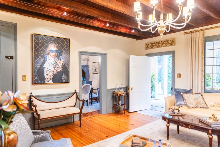 A Pleasant Hill House living room with wooden beams and a chandelier.