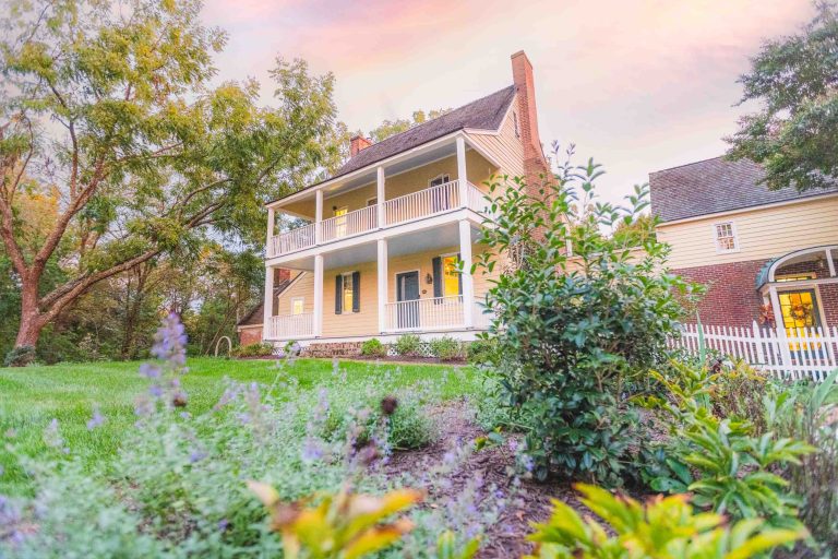 Pleasant yellow house in the middle of a green lawn near Pleasant Hill.