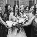 A black and white wedding portrait of a bride and her bridesmaids at Savage Mill.